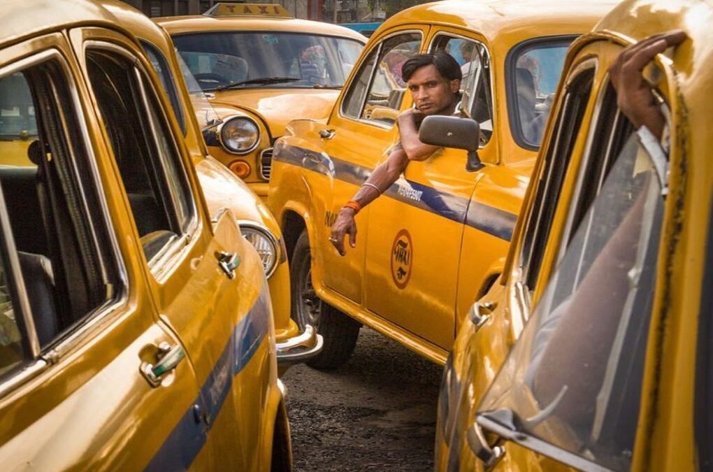 Yellow taxis on a busy Kolkata street, reflecting how nostalgia makes movies better by connecting cinema with everyday memories.